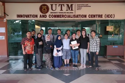 A group of interns in front of the Innovation and Commercialisation Centre at Universiti Teknologi Malaysia