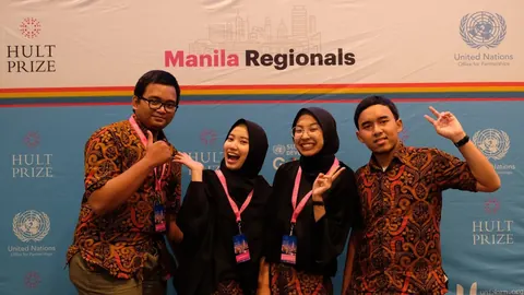 Adjie and three teammates in batik and black, posing in front of the Hult Prize Manila Regionals backdrop